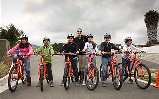 Adams schoolkids and PE teacher Julie Churchman with a new fleet of bikes.
