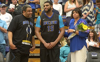 <b>FUTURE SUN:</b> Alan Williams is flanked by his parents, Cody and Jeri, during a ceremony before his last UCSB home basketball game in 2015.