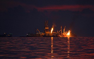 Flames from burning natural gas and oil continued months after the <em>Deepwater Horizon</em> oil platform sank in April 2010.