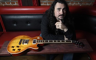 Alastair Greene poses for photos at the Red Piano bar. (Dec. 6, 2017)