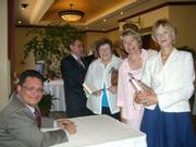 Montecito resident Joan Rocco buys an autographed copy of <em>The Mexican Mafia</em> from Tony Rafael.
