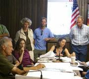 Kay (standing in tan jacket) and Dave Peterson (standing next to flag) plan to appeal the Largura project.