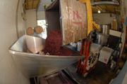 Where Are the Virgins? Wine stomping looks a little different these days as Jaffurs owner Craig Jaffurs lets his forklift do the dirty work of unloading a fermenting bin's worth of grapes into the press.