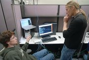 Giovanni Vigna (right) discusses possible hacking strategies with one of his computer programming students during a hacking competition in December 2007.