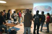 Giovanni (far left) shows the two UCSB teams the timeline of attacks at the end of the competition.