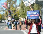 Maria Papacostaki (foreground) and a crowd of 20 gathered at noon on Moday at the corner of State and Carrillo promoting Hillary Clinton in advance of Super Tuesday.