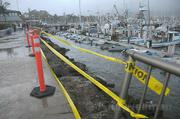 Across from the S.B. Yacht Club, Sunday's waves crashed across the breakwater and threw a woman through the metal railing and into the harbor