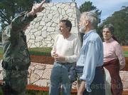 Larry Purcell (center), Ed Ehmke (foreground), and Mary Jane Parrine attempt to plead their case to Vandenberg security as they are ordered to leave.