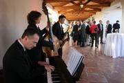 Justin Claveria (on sax) and crew entertain the multinational execs at the Bacara on Thursday.
