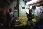 In a slum on the outskirts of Chennai, India's fourth largest city and a hub of automakers and high-tech businesses, this family of five sleeps together in this small room, one block from the smolderÂ-ing trash dump. This father can make close to $2.50 a day at a sawmill-considerably higher than the typical dollar-a-day wage for laborers-but there are only 10 days of work per month.