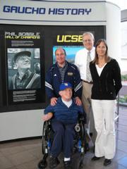 The UCSB Gauchos' #1 fan Phil Womble, who's in his 70s despite being born with cerebral palsy, is joined by, from left, UCSB sports information director Bill Mahoney, athletic director Gary Cunningham, and associate athletic director Diane O'Brien.