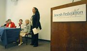 Rabbi Allison Conyer (center) sang and guided the survivors reading of poetry and ceremonial lighting of candles.