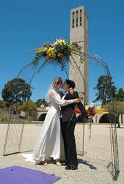 Adrienne (in wedding dress) and Connie kiss after vows at UCSB's annual Queer Wedding 2005.