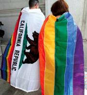 Gay rights supporters wear the California state flag and a gay pride flag outside of the state's Supreme Court
building in San Francisco last Thursday after the court's ruling was announced.