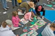 Roosevelt 2nd graders carefully lay out their designs and begin to work a small part of the overall painting.