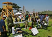 Sailors show kids the ropes on an M2 .50 caliber and M240G machine guns and on an MK19 40mm grenade launcher.