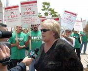 Donna Carpenter, vice chancellor for administrative services, speaks with the media during the strike on July 14.