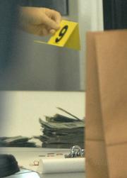 Money found in a restroom trash can at the Goleta Toyota dealership being taken into evidence