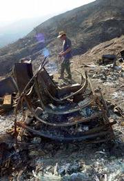 Home, Burned Home: A tool shed, warped beyond recognition by the Gap Fire. "I find these metallic tears to be poignant," Murray said of the melted masses.