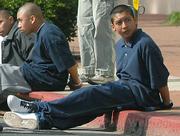 Ricardo Juarez sits handcuffed on the curb of State Street after the March 14, 2007 stabbing.