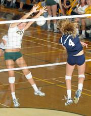 Dos Pueblos High's Samantha Wopat (#4) powers a spike past Madison Hamilton (#20) of Santa Barbara in last week's Channel League volleyball championship match. Dos Pueblos won in five games, and both teams advanced to the CIF playoffs.