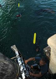 After jumping in and practicing pulling a person to safety its back up the ladder to the pier to do it again