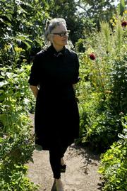 Foster, a well-known and serious gardener who takes "plant safaris" up the coast in search of interesting flora, strolls through the garden court next to her Santa Barbara home.