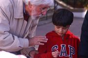 Jean-Michel Cousteau educating a youngster about the harms of plastic shopping bags to the environment.