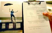 Students fill out study sheets on the Portraits of Survival exhibit and write questions for later discussion