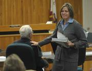 District Attorney Mary Barron gives James Wheeler a pat on the shoulder after sentencing