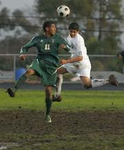 Santa Barbara Don Peter Aguilar (left) goes up against Dos Pueblos Charger Eduardo Cortez.