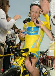 Before he can get his helmet off Levi Leipheimer starts taking questions at the finish of the AMGEN time trials in Solvang, CA