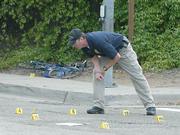 SBPD traffic investigator Mark Hunt surveys the scene of a accident where bicyclist Johan Montoyaon was hit and severly injured by an SUV on Mission St. at the 101 underpass April 7, 2008