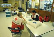 Red Cross Shelter volunteers Janet Napier (left) and Harley Hahn chat in wee hours of a slow night at the Dos Pueblos High School Gym. Out of all the evacuated ares only 10 people came in seeking shelter.