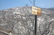 Sign along Highway 154 depicts damage done during Friday evening's fire run towards Painted Cave.