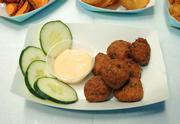 Fresh-made falafels served with cucumber slices and spicy, creamy peanut dipping sauce.