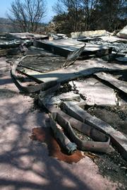 Evidence of firefighters' last-minute escape from their temporary command post at the property.