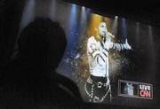 A mourning fan watches the Michael Jackson memorial in the Arlington Theatre via live video feed from the Staples Center July 7, 2009