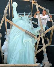 Rex Stephens standing next to the 500-pound, 16-foot-tall Statue of Liberty replica commissioned by the Spirit of '76 Foundation arrived in Santa Barbara on Monday, July 6, and will be unveiled at this weekend's French Festival in Oak Park.