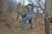 Volunteers on National Trails Day June 13 help to remove loose rock that has tumbled down off trail.