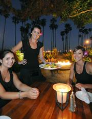 FisHouse servers (L to R) Ronni, Taler, and Sara, on the patio that overlooks the beach