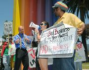 Outside the Double Tree Resort budget cut protesters hold a mock award ceremony giving Mark Yudof "the 2009 Bad Business of the Year award"