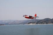 Martin Mars Superscooper is seen here taking off from the Cachuma after filling up with about 7,200 gallons of water to drop on the fire lines of the La Brea Fire