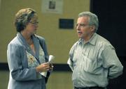 Iya Falcone talks with POA chief Sgt. Charles McChesney after the mayoral forum on 8/14/09