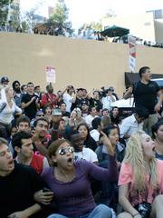 Students sit and chant angrily in front of a Regent-filled van, rendering escape from the UCLA campus impossible after the meetings on Thursday.