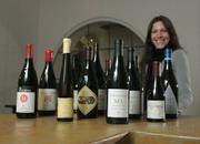 Tasting room associate Eve Sommer-Belin with a few of the labels from the "Friends of the Wine Cask" wine alliance