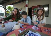 Outside (L to R) Trish Geyling, with ten-year-old son Max and seven-year-old daughter Olivia, make cards for the guests and decorations for the Rescue MIssion