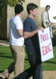 Dec. 31, 2009 Judge Brian Hill, (far right) who oversaw the 2007-08 Frimpong case, happens by as a small group marches in support of Eric Frimpong who they believe was wrongly convicted of rape.
