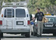 SBPD crime scene investigator Mike Ullemeyer with collected evidence from a shooting at 1535 Gillespie Mar. 1, 2010
