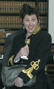 Mar. 1, 2010 leaving the courtroom Evi Quaid mugs for the camera holding up Randy Quaid's 1988 Golden Globe award for his role in LBJ: The Early Years